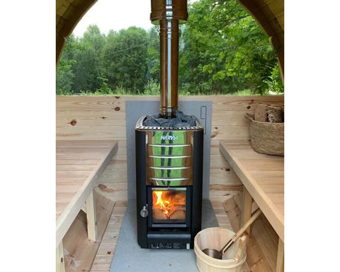 Harvia M3 black and stainless steel wood-burning sauna stove with visible flames and gray stones on top