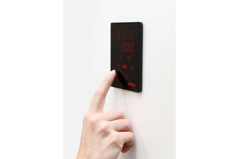 Harvia Moderna XE black electric sauna heater with digital control panel and gray stones on white background