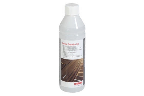 Clear plastic bottle with white ribbed cap containing Harvia Paraffin Oil, product label showing wood treatment use, on white