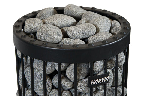Harvia sauna heater stones in black metal basket with rounded gray stones, flat lay on white background