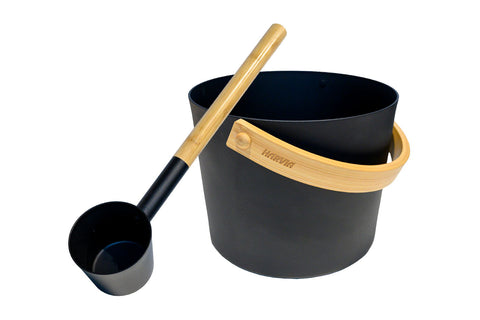 Black steel sauna pail with bamboo handle strap and matching black aluminum ladle with wooden handle, on white background