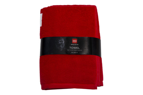 Red towel with white Harvia text, flat lay on white background