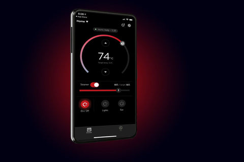 Harvia Xenio smartphone app displaying sauna controls with 74°C temperature gauge, steamer toggle, and lighting and fan butto