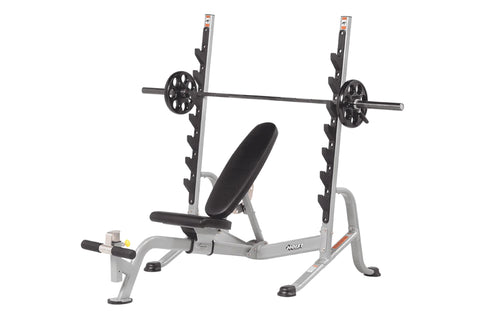 Hoist 7-position Olympic bench press with silver metal frame, black padded seat and backrest, and loaded barbell bar on white
