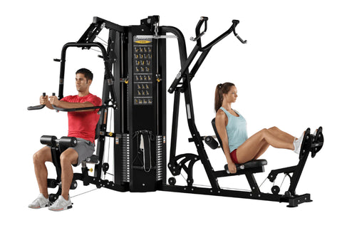 Black multi-station gym equipment with two exercisers demonstrating different exercises on white background