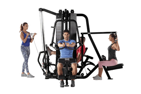 Hoist 4-Stack Multi Gym with black frame and red seat pad, three models demonstrating exercises on white background