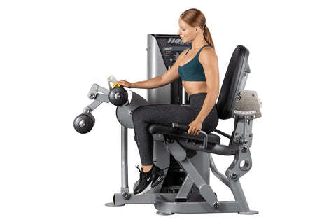 Hoist ROC-IT leg curl machine with gray and black frame, padded backrest and leg extension arms on white background