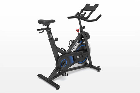 Black and blue indoor exercise bike with tablet holder and resistance dial, on white background
