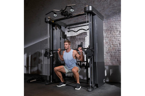 Black and silver Inspire Fitness FT2 Pro Smith functional trainer with dual weight stacks and foot platform on white backgrou