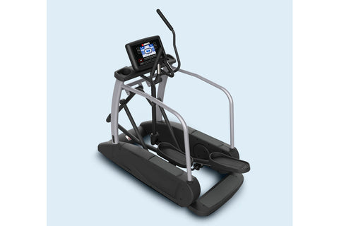 Landice E9 commercial elliptical with black foot pedals, gray frame, digital console, and safety handrails on light blue back