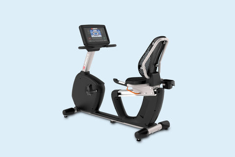 Landice R7 black recumbent exercise bike with digital console display and mesh seat back, on light blue background