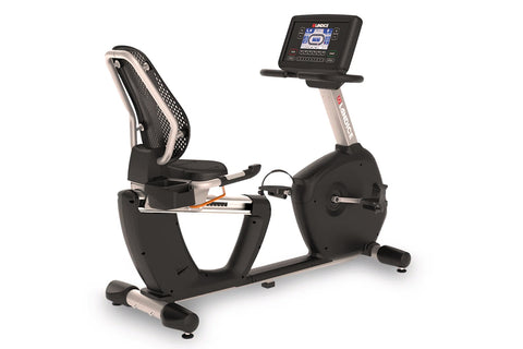 Landice R9 black recumbent exercise bike with digital console and mesh backrest on light blue background