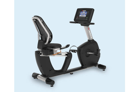 Landice R9 black recumbent exercise bike with digital console and mesh backrest on light blue background
