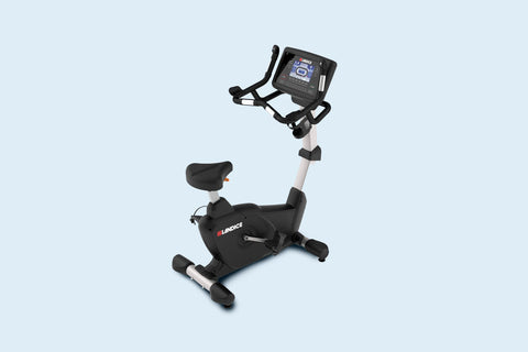 Landice U9 commercial upright exercise bike with black and silver frame, digital console display, and black padded seat on wh