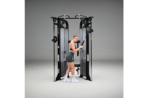 Life Fitness Signature Series black and silver dual adjustable pulley machine with cable systems and handles on white backgro