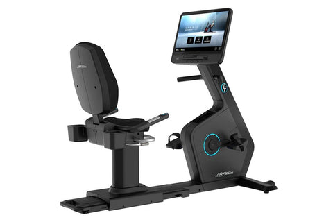 Black recumbent exercise bike with blue accent lighting, digital touchscreen display, padded seat, and foot pedals on white b