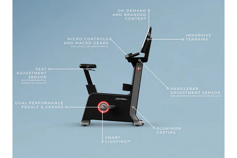 Black upright exercise bike with cyan accents, digital touchscreen display, adjustable seat and handlebars, on white backgrou