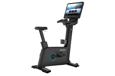 Black upright exercise bike with cyan accents, digital touchscreen display, adjustable seat and handlebars, on white backgrou