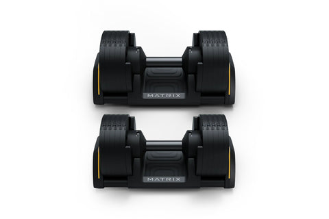 Pair of black Matrix adjustable dumbbells with yellow accents and textured grip handles, displayed on white background
