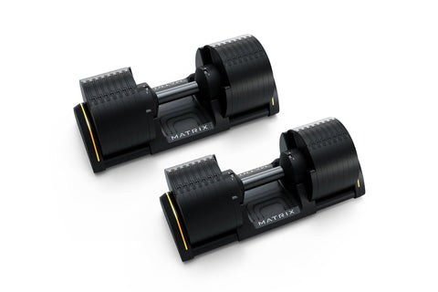 Pair of Matrix adjustable dumbbells with black rubber grip plates, steel handles, and yellow accents on base, shown on white 