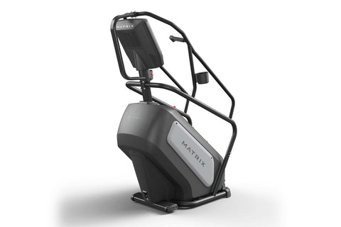Matrix Endurance ClimbMill with black frame, gray and white base, digital display console, and dual black handrails on white 