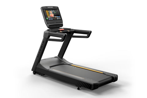Black Matrix commercial treadmill with digital touchscreen display showing workout interface, wide running deck, and orange a