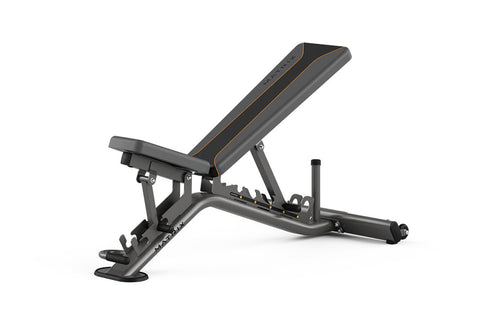 Matrix multi-adjustable weight bench in charcoal gray with gold accent lines, adjustable backrest, and weighted leg extension