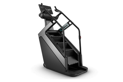 Matrix Onyx ClimbMill stair climbing machine with black frame, digital display console, and textured pedal platform on white 