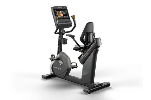 Matrix Performance Hybrid Cycle upright exercise bike with digital display screen and black padded seat on white background