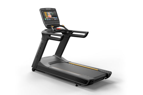 Black and gray commercial treadmill with integrated touchscreen display, gold accents, and cushioned running deck on white ba