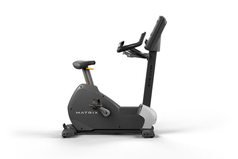 Matrix black upright exercise bike with digital touchscreen console, adjustable handlebars and seat, on white background