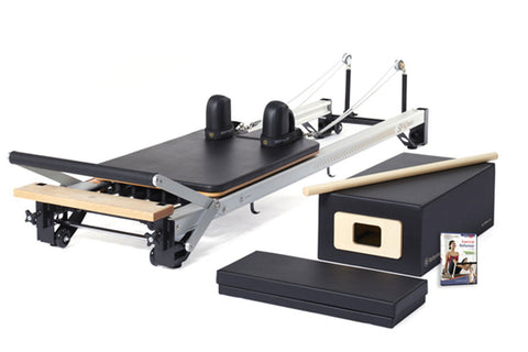 Black and cream Merrithew SPX home pilates reformer with carriage, footbar, and accessories on white background, marked sold