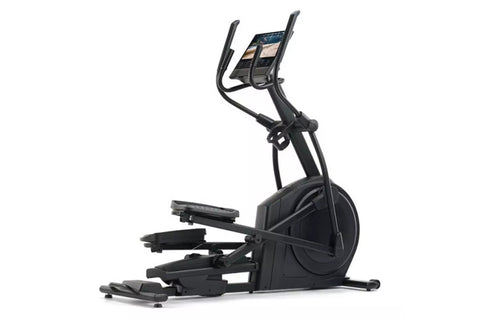Black elliptical machine with curved handles, digital display console, and moving foot pedals on white background