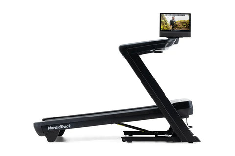 NordicTrack Commercial 1750 black treadmill with attached display screen showing outdoor workout video on white background