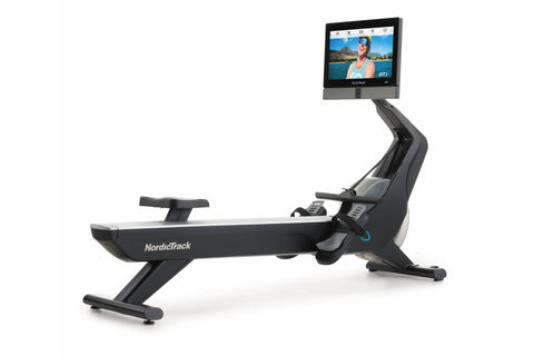 NordicTrack RW900 black rowing machine with gray accents and tablet holder displaying fitness class on white background