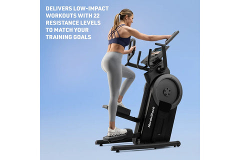 Black NordicTrack step climber with digital display, moving handlebars, and foot pedals on white background