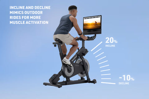 NordicTrack X24 black indoor exercise bike with attached tablet displaying sunset cycling video on white background