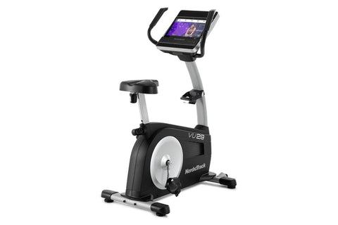 NordicTrack VU 29 upright exercise bike with black and gray frame, digital display console, and pedals on white background