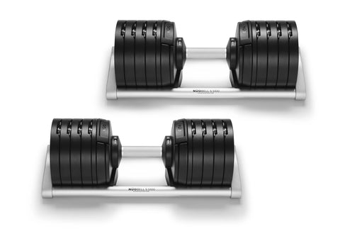 Pair of NuoBell adjustable dumbbells with black rubber-coated plates and silver handle, shown stacked on white background