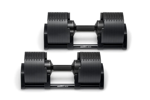 Pair of matte black adjustable dumbbells with ribbed weight plates and black handles on white background