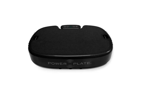 Black Power Plate vibration machine with digital display and curved platform on white background