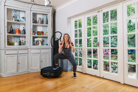 Power Plate My5 black vibration training machine with circular platform base and vertical handle on white background