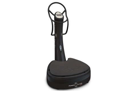 Black Power Plate Pro5 vibration fitness machine with digital display, control handles, and wide platform base on white backg