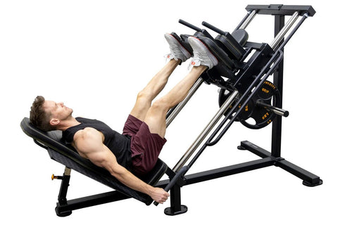 Black and silver leg press hack squat combo machine with padded seat and footplate on white background