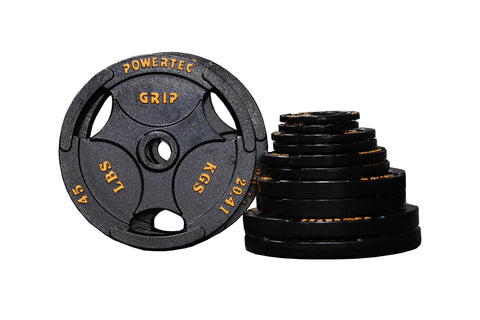 Powertec Grip cast iron Olympic weight plates set in black with orange text markings, including one 45lb plate and stacked pl