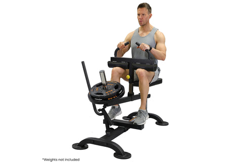 Male model using black seated calf raise machine with weight plate storage, demonstrating exercise form on white background