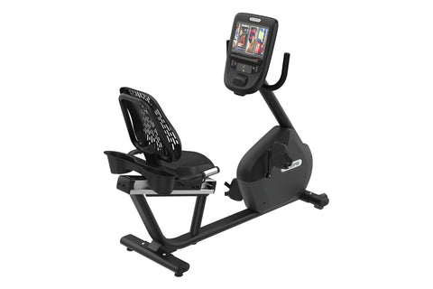 Black recumbent exercise bike with digital display console showing workout metrics, perforated backrest, and footrest on whit