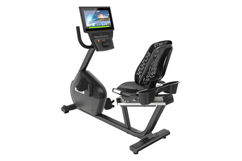 Precor RBK 685 recumbent exercise bike with black frame, padded seat, and touchscreen console displaying workout metrics on w