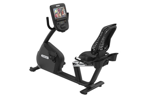 Black recumbent exercise bike with digital console displaying workout metrics, featuring a padded seat with backrest and foot