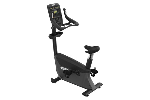 Black upright stationary exercise bike with digital console display, curved handlebars, and padded seat on white background